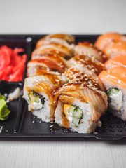 Japanese food sushi roll with raw fish and rice. delivery plastic boxes