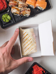 Japanese food sushi roll with raw fish and rice. delivery plastic boxes