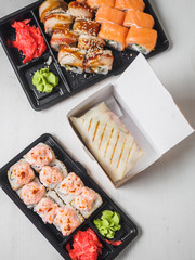 Japanese food sushi roll with raw fish and rice. delivery plastic boxes