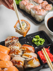 Japanese food sushi roll with raw fish and rice. delivery plastic boxes