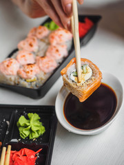 Japanese food sushi roll with raw fish and rice. delivery plastic boxes