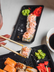 Japanese food sushi roll with raw fish and rice. delivery plastic boxes