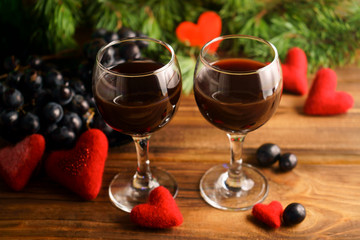 Two glasses of wine and grapes on the table. Date on Valentine's Day. 