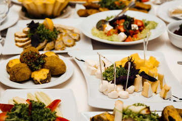 Beautifully decorated catering banquet table with different food snacks and appetizers on corporate party event or wedding celebration