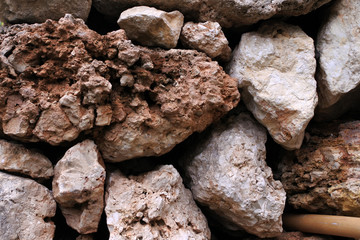 stone wall of an ancient temple. background with beige weathered stones.