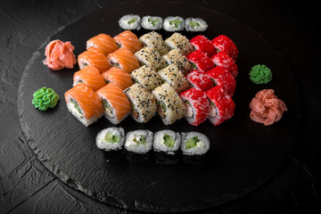 Sushi set of Philadelphia, California with fresh ingredients on black background. Sushi menu. Japanese food. 