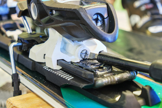 Screw for adjusting forward pressure in a ski binding using a screwdriver, after clipping the ski boot in first.
