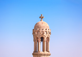 Fototapeta na wymiar top of belfry with stone cross