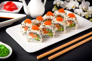 Sushi roll sushi  with fresh juicy salmon, Philadelphia cheese, sesame, red caviar salmon roe, avocado. Sushi menu. Japanese food. Asian food