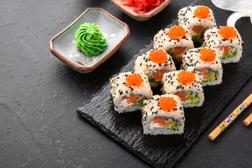 Sushi roll sushi  with fresh juicy salmon, Philadelphia cheese, sesame, red caviar salmon roe, avocado. Sushi menu. Japanese food. Asian food