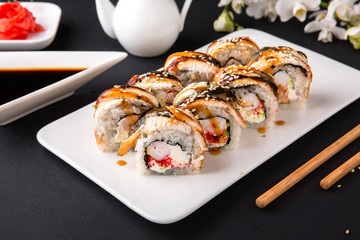 Unagi roll with smoked eel, with royal shrimp avocado, cream with Philadelphia cheese, tobiko caviar. Sushi menu. Japanese food. 