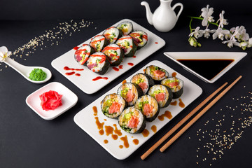 Hot fried Sushi Roll with salmon, tuna, avocado and cheese. Sushi menu. Japanese food.