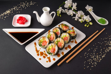 Hot fried Sushi Roll with salmon, tuna, avocado and cheese. Sushi menu. Japanese food.