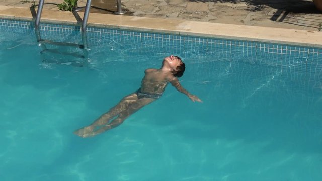 Kas, Turkey - 28th of September 2019: 4K Child tries to float on his back but fails