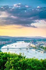 Fototapeta premium A view along the Danube River of Budapest, Hungary from Gellert Hill at sunset.