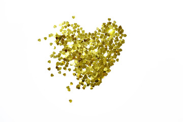 background, golden sparkles of hearts confetti laid out in the shape of a heart