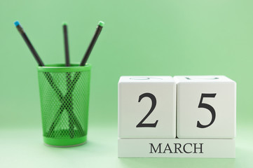 Desk calendar of two cubes for March 25