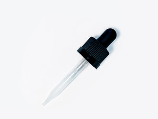 View of a tincture dropper with a black rubber top against a white background