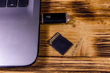 Modern laptop, sd and flash memory card on a wooden desk