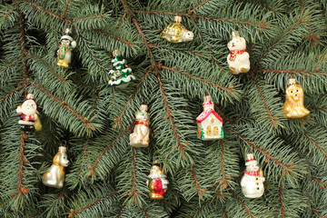 Winter composition - blue spruce tree twigs and toys background