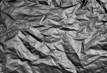 Crumpled metal foil texture background