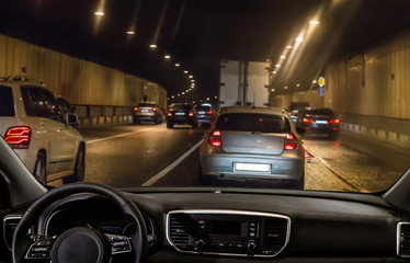 View from the car through the windshield of traffic in a tunnel