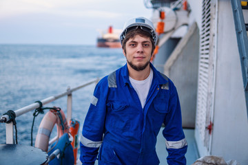 Marine Deck Officer or Chief mate on deck of offshore vessel or ship , wearing PPE personal...