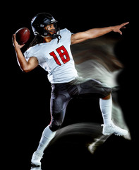 one african american football player man studio shot isolated on black background with light...