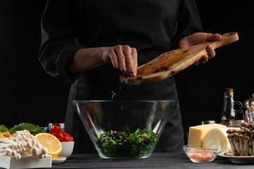 The chef pours Italian masks to prepare a delicious and fresh salad. Vegetarian and fresh food,...