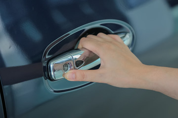 Woman hand on open the new car door