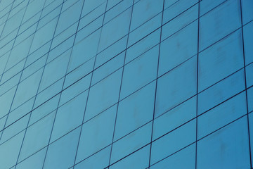 Fototapeta na wymiar Blue glass windows of modern office building