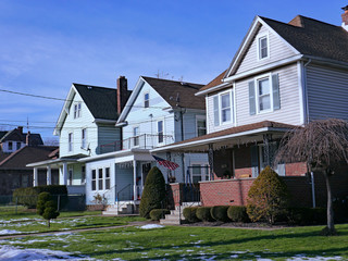 Street of older American detached houses with gables and porches