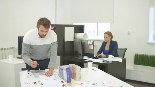 Architect is searching for drawing of houses, his workmate found it
