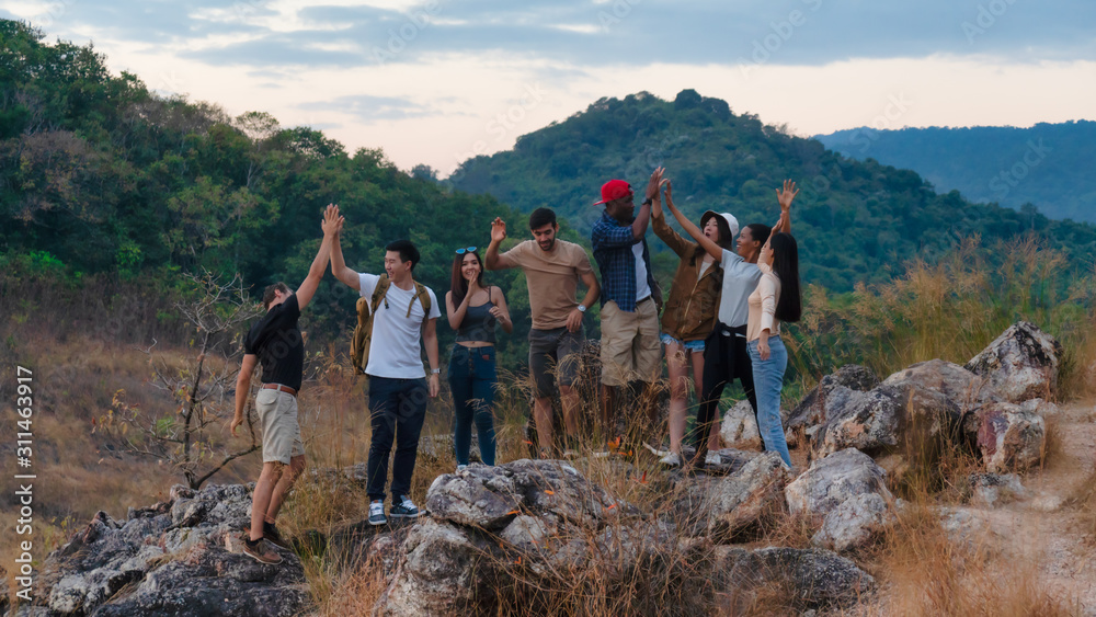 Wall mural group of diversity people having fun together climbing up rocky mountains