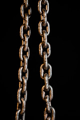 Obraz premium Rusty chains weathering. Chain on black background.