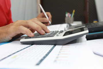 Concept Business Hand man Writing tax on desk about at home office, Vintage, Sunset light.Selective Focus