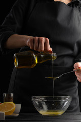 Freezing food prepares a vegetarian salad with seafood by the chef in the home kitchen. A concrete wall background with a text area for restaurant menu design.