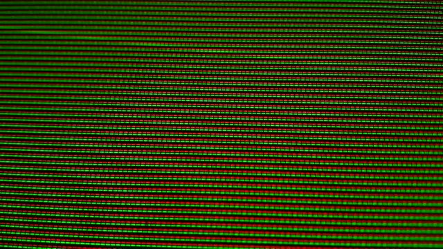 Close-up of the Monitor's Pixels. RGB pixels on the TV during the screening of the film, macro, close-up. Red, blue and green sub pixels create an image on the screen