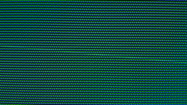 Close-up of the Monitor's Pixels. RGB pixels on the TV during the screening of the film, macro, close-up. Red, blue and green sub pixels create an image on the screen