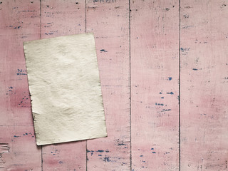 paper on pink wooden background