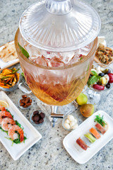 Large crystal chalice drink serving dispenser with sides of shrimp cocktail vegetables and other things