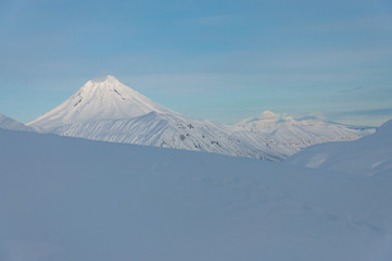 Winter view of Kamchatka volcanoes full of snow.