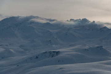Winter view of Kamchatka volcanoes full of snow.