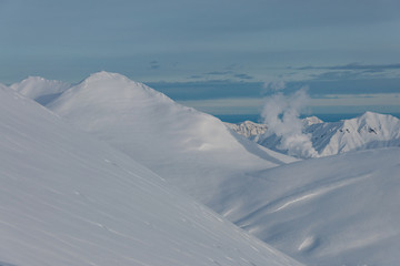 Winter view of Kamchatka volcanoes full of snow.