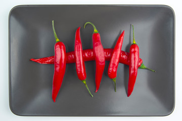 Red hot pepper close up on a grey plate Healthy vegetable food and vitamins
