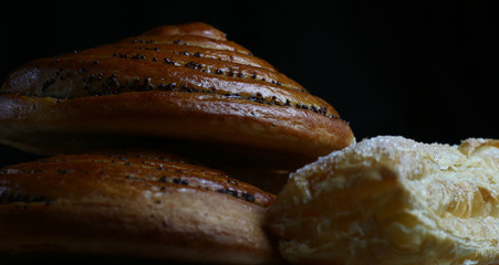 fresh delicious pastries in a beam of light on a dark background