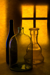 Still life with glass objects on a window background
