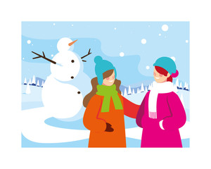 women with snowman in winter landscape