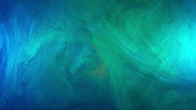 saturated deep blue, ocean blue color acrylic ink flowing and swirling into water, heavily pigmented and beautiful colors make for pretty multi colored clouds for background footage and effects.