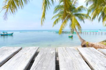 Fototapeta na wymiar empty wooden table on the blurred background of the beach